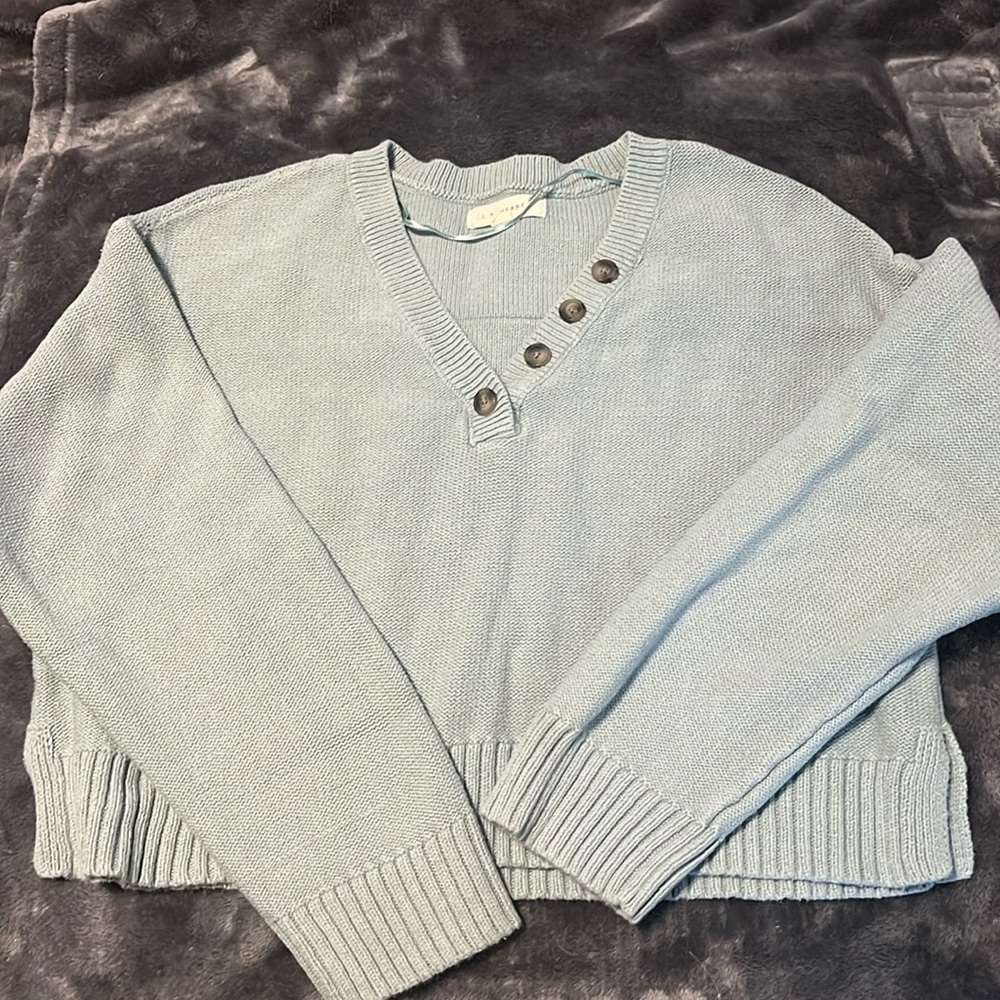 Cropped pale blue sweater with button details
